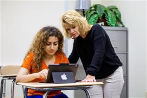 A BVISP student and her teacher work together.