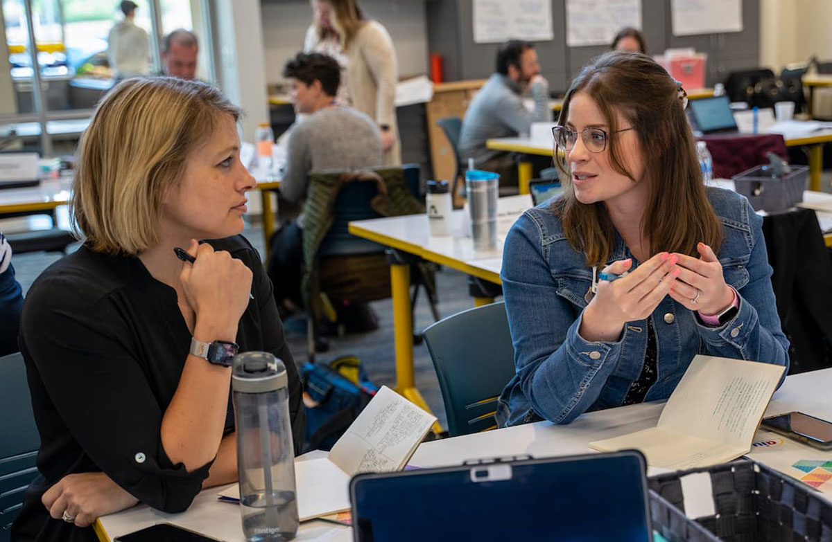 Two educators in a discussion