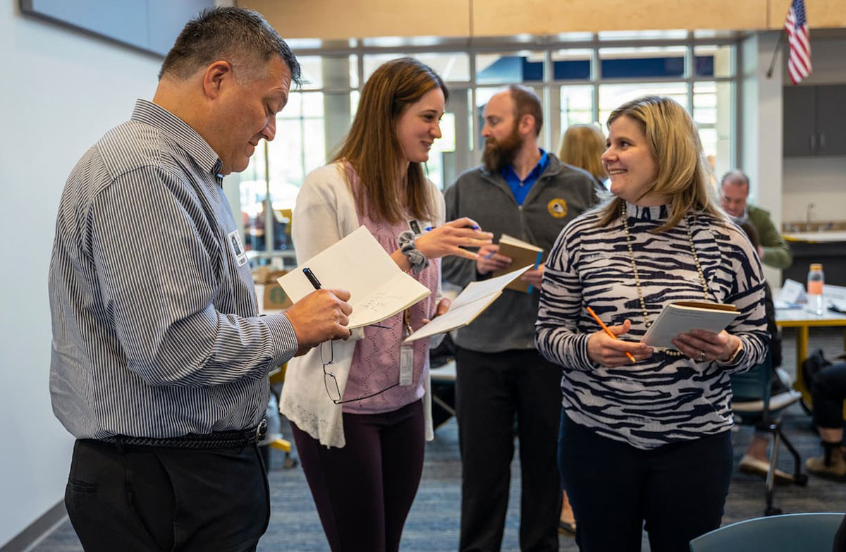 Educators in a discussion at a workshop