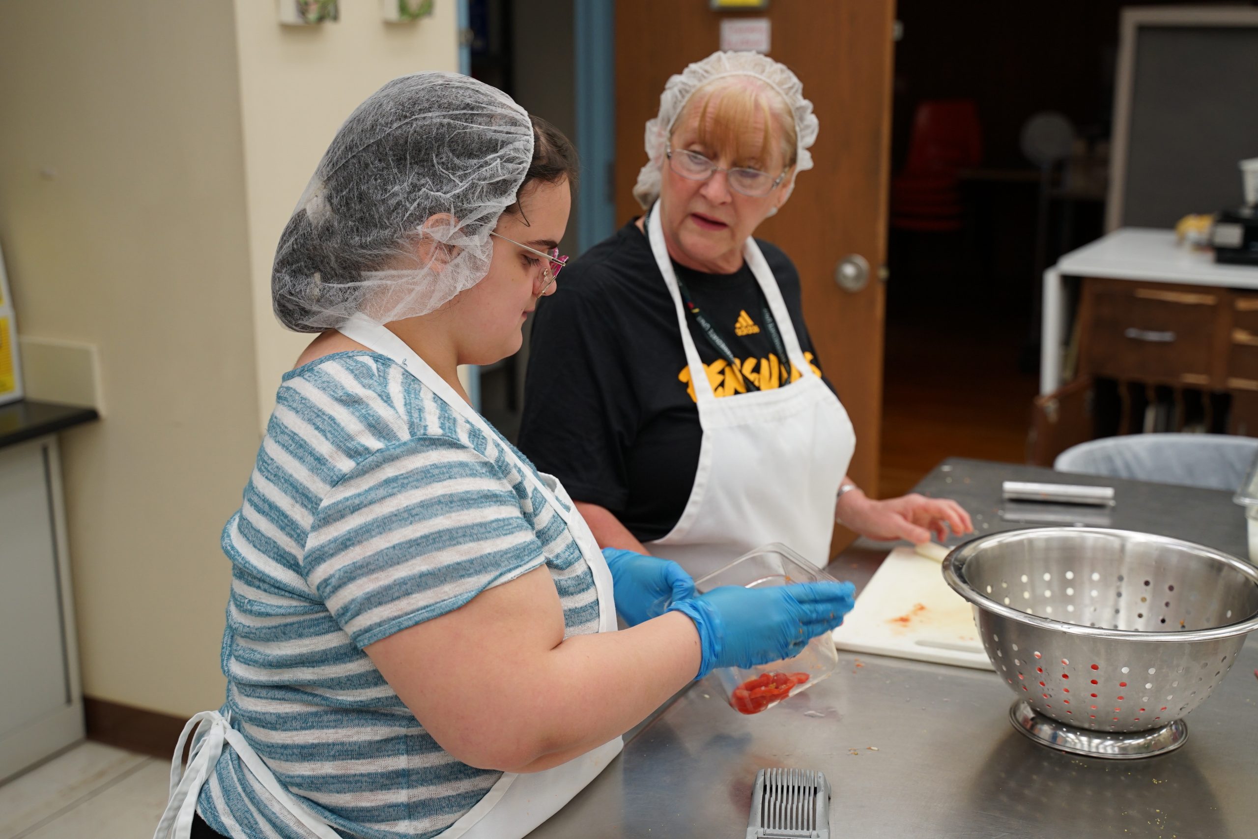 Student receives instruction at Sunrise School Food Service Program