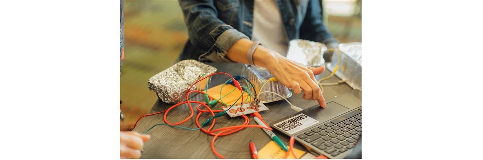 Person on laptop programming equipment